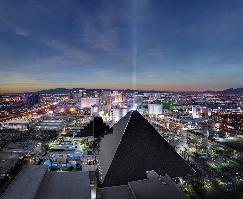 Luxor Hotel and Casino black glass pyramid and Sphinx statue lit at night on the Strip